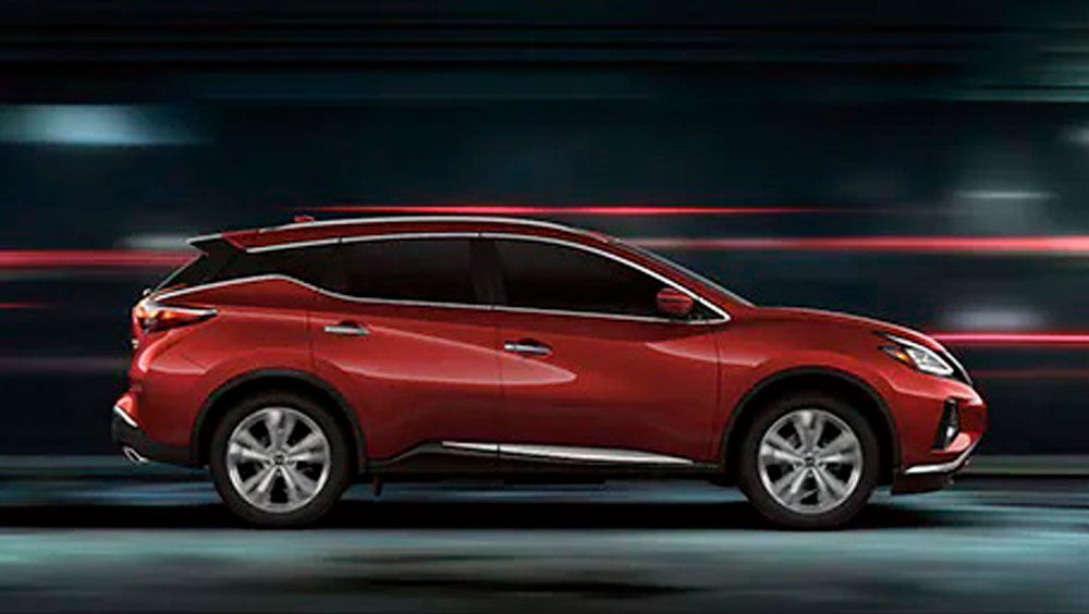 2023 Nissan Murano shown in profile driving down a street at night illustrating performance. | Fairbanks Nissan in Fairbanks AK